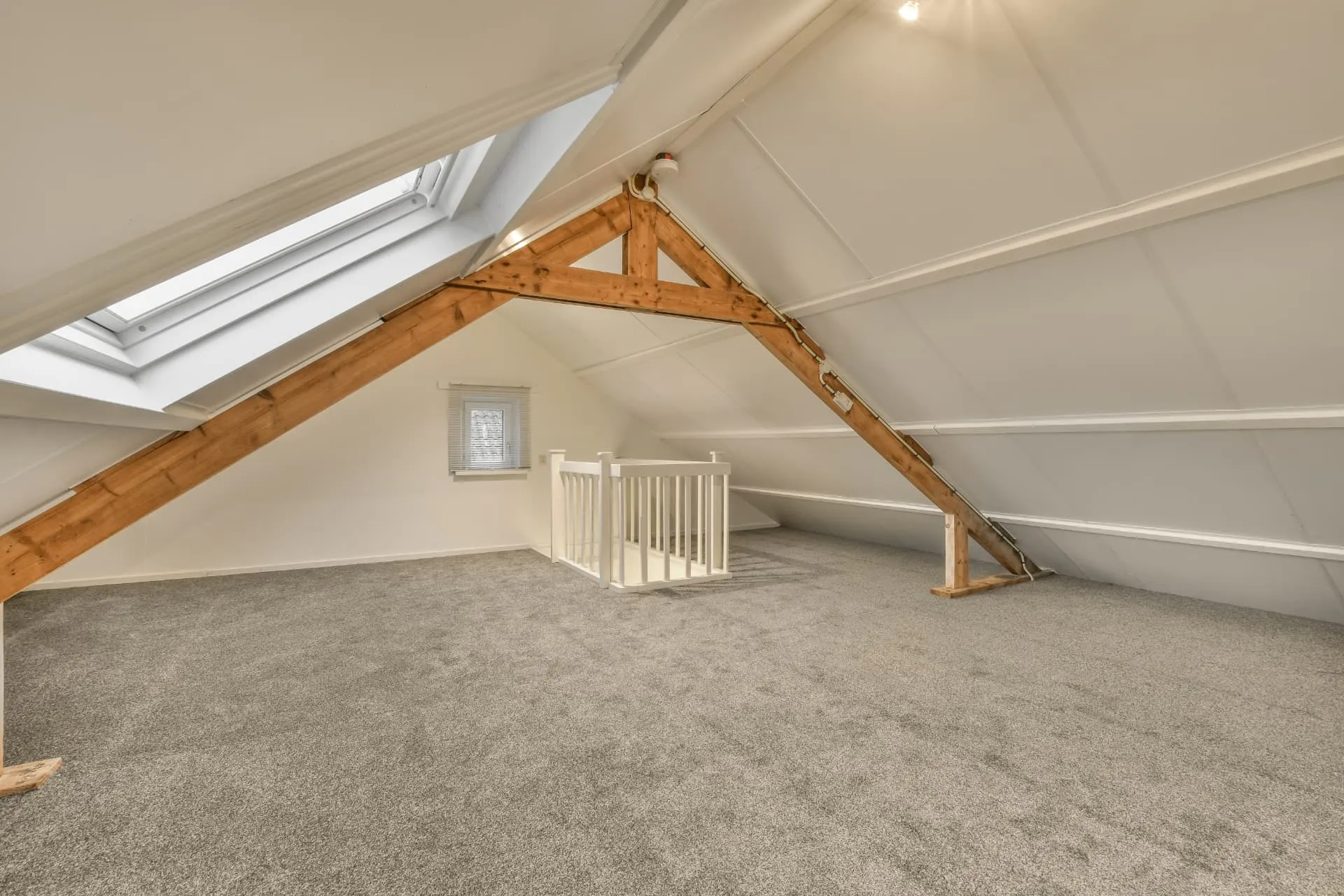 Bright loft conversion with exposed timber trusses, rooflight and new staircase